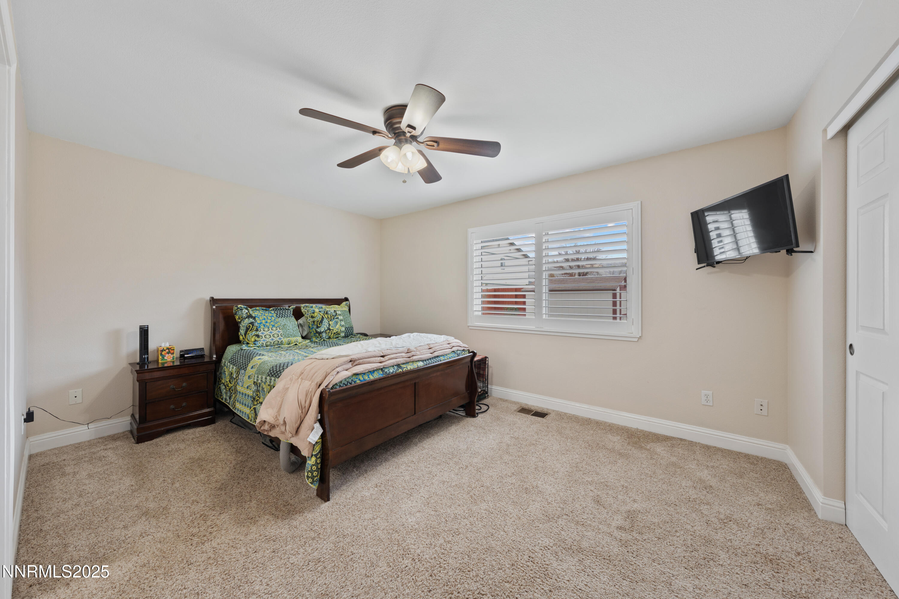 17785 Fortune Court Reno, NV 89508 - Photo 20 of 43 a bed sitting in a bedroom next to a window