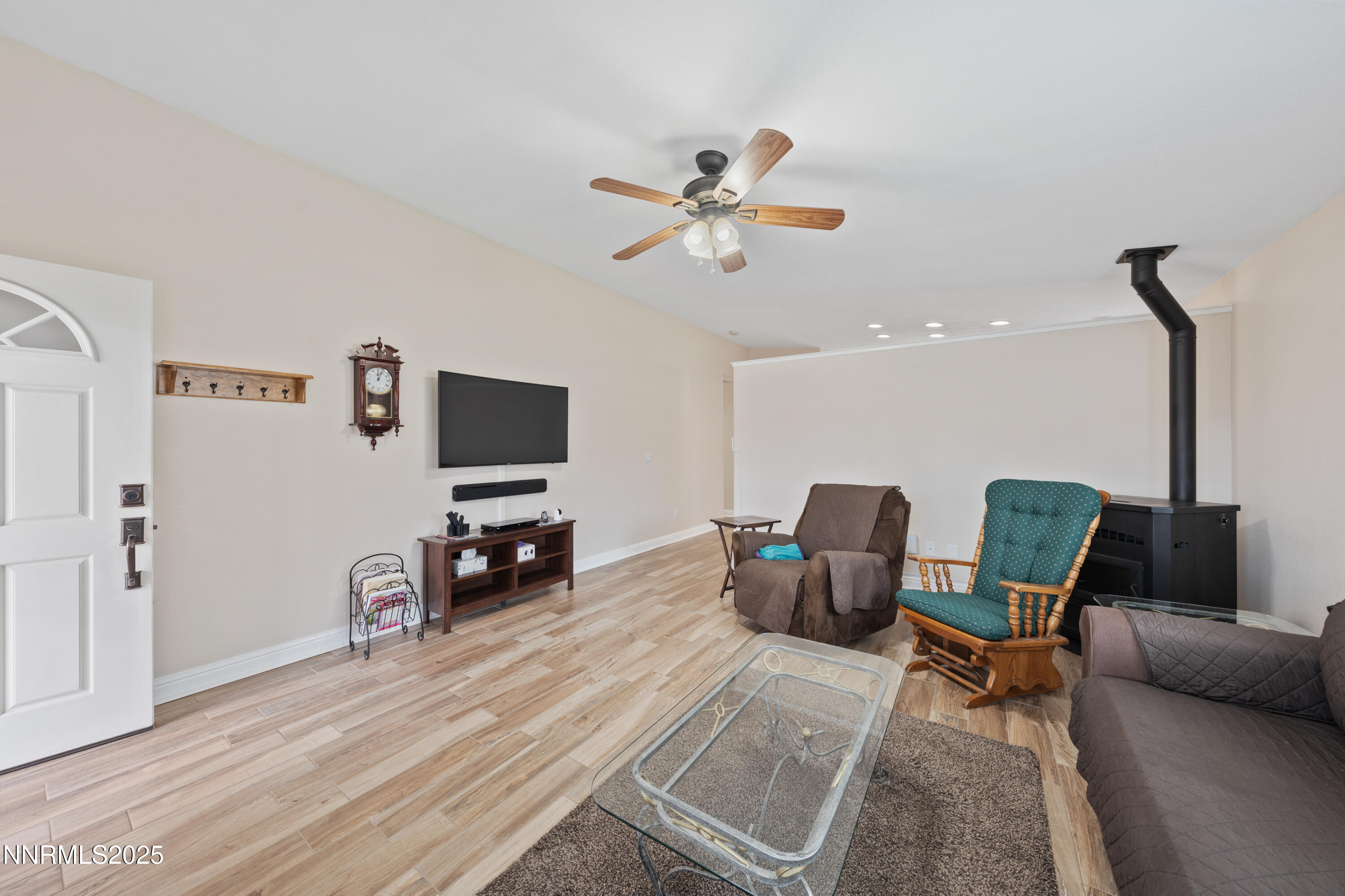 17785 Fortune Court Reno, NV 89508 - Photo 5 of 43 a living room with furniture and a flat screen tv with wooden floor