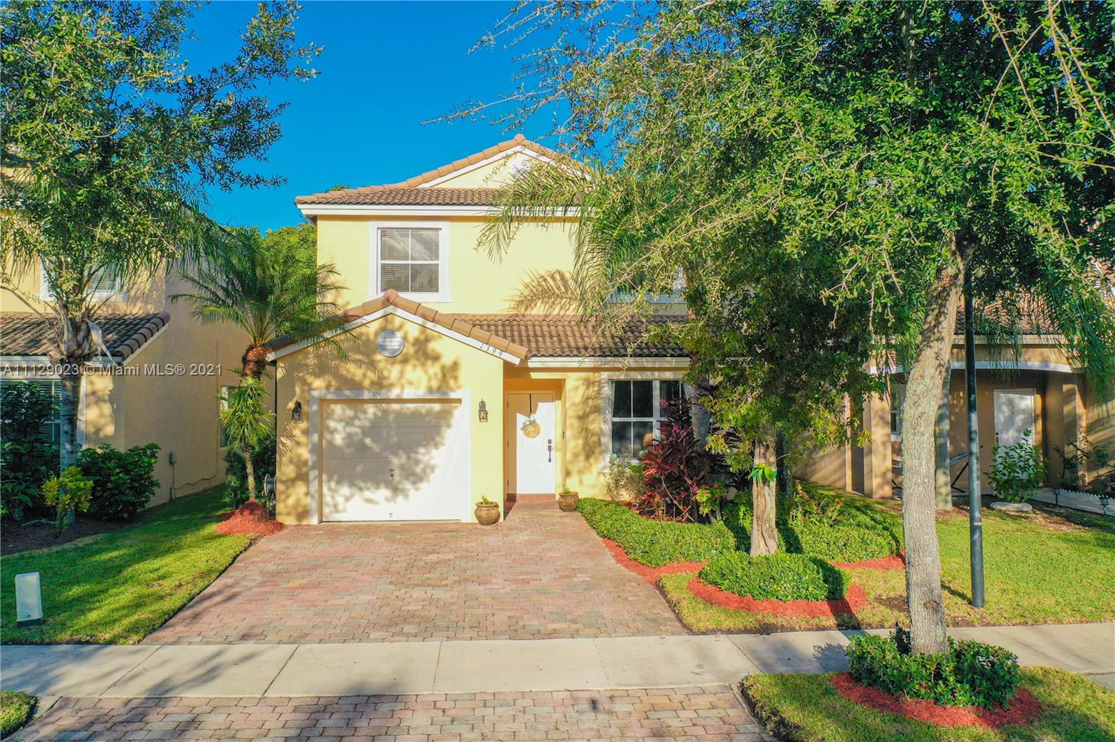 1399 Southeast 20th Road Homestead, FL 33035 - Photo 1 of 50 a front view of a house with a yard and potted plants