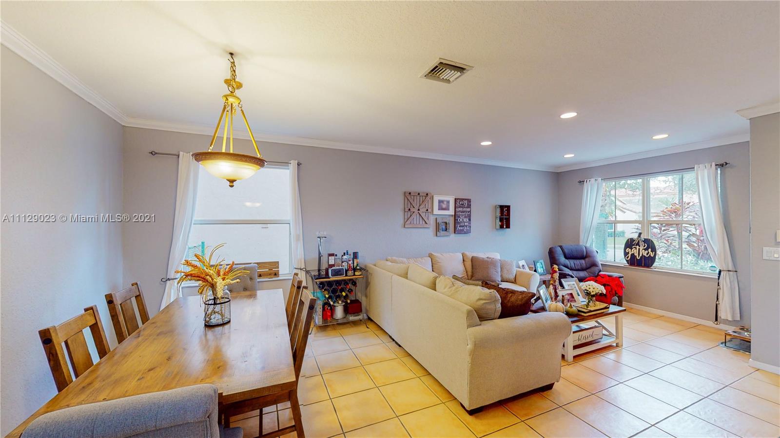 1399 Southeast 20th Road Homestead, FL 33035 - Photo 2 of 50 a living room with furniture and a chandelier