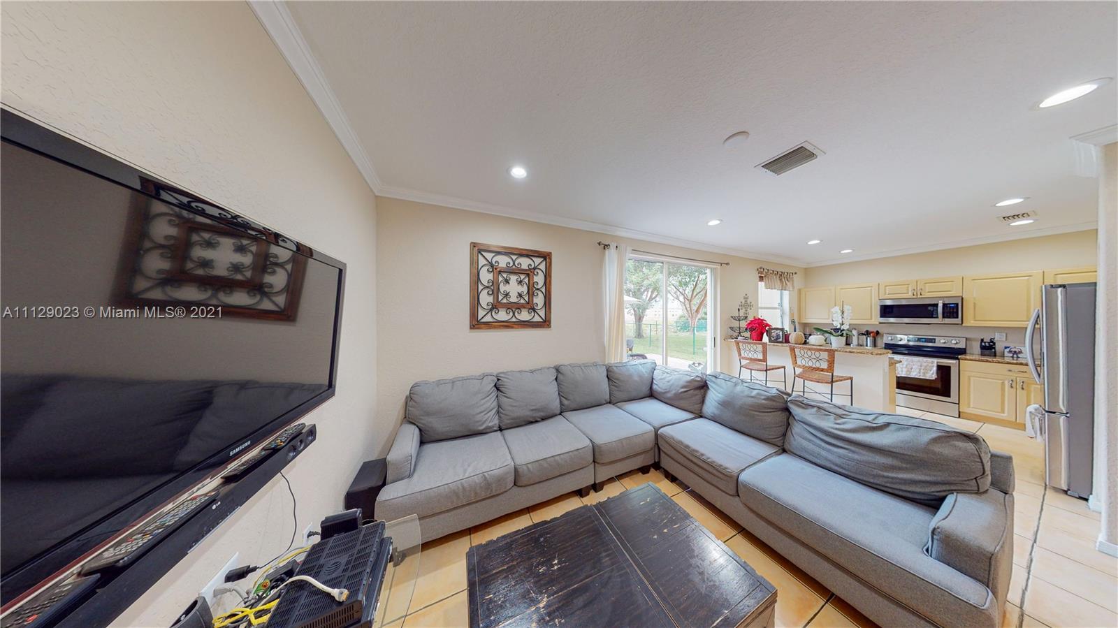1399 Southeast 20th Road Homestead, FL 33035 - Photo 11 of 50 a living room with furniture and a flat screen tv