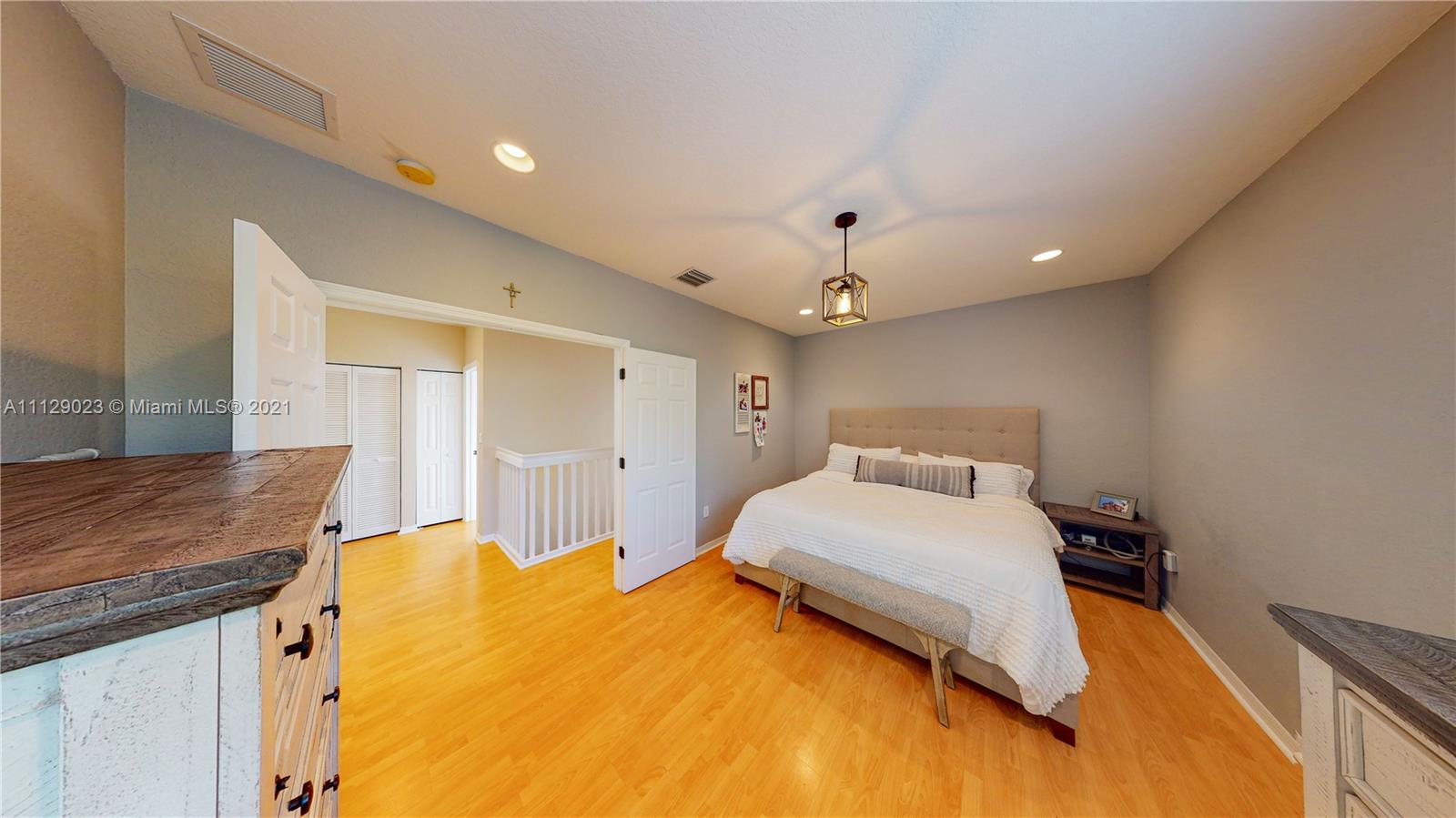 1399 Southeast 20th Road Homestead, FL 33035 - Photo 14 of 50 a bedroom with a bed and a chandelier