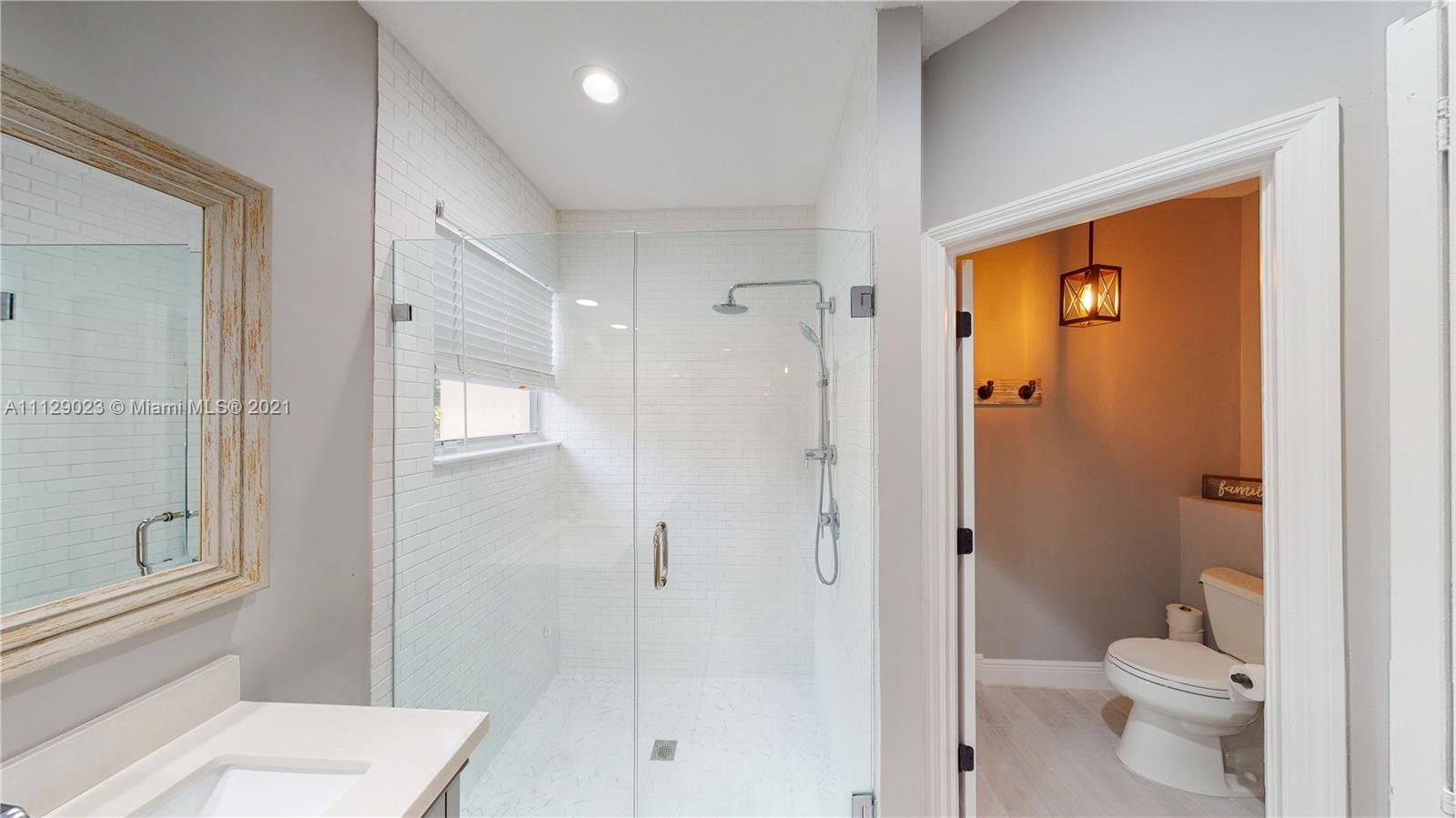 1399 Southeast 20th Road Homestead, FL 33035 - Photo 17 of 50 a bathroom with a shower a toilet and a sink