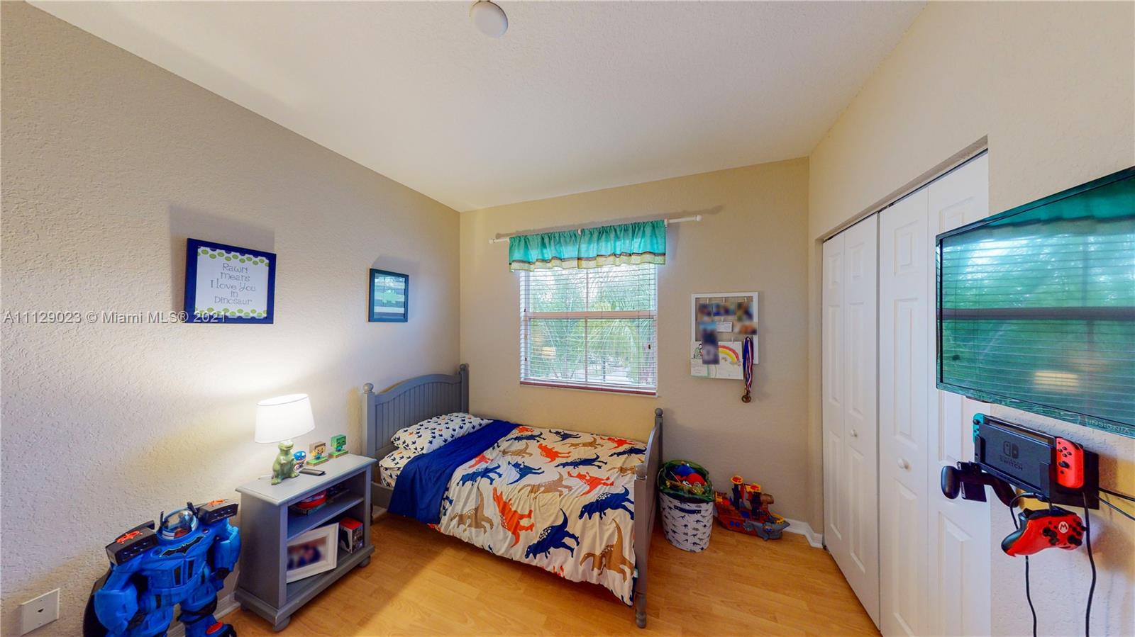 1399 Southeast 20th Road Homestead, FL 33035 - Photo 19 of 50 a bedroom with a bed and a window