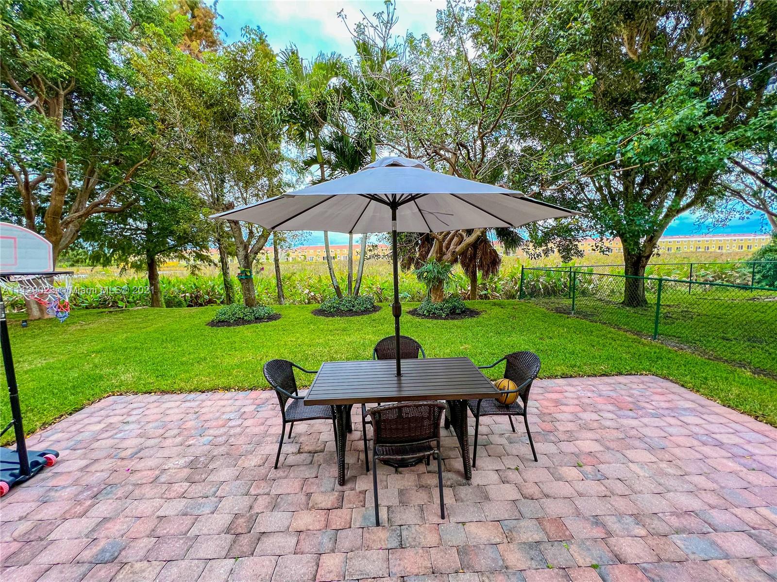 1399 Southeast 20th Road Homestead, FL 33035 - Photo 25 of 50 a view of a patio with a yard table and chairs