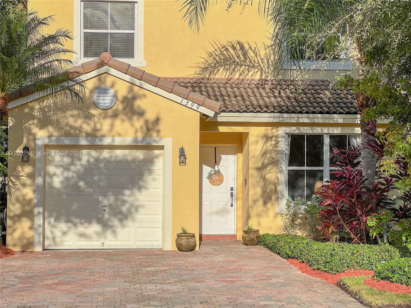1399 Southeast 20th Road Homestead, FL 33035 - Photo 4 of 50 a front view of a house with a glass door