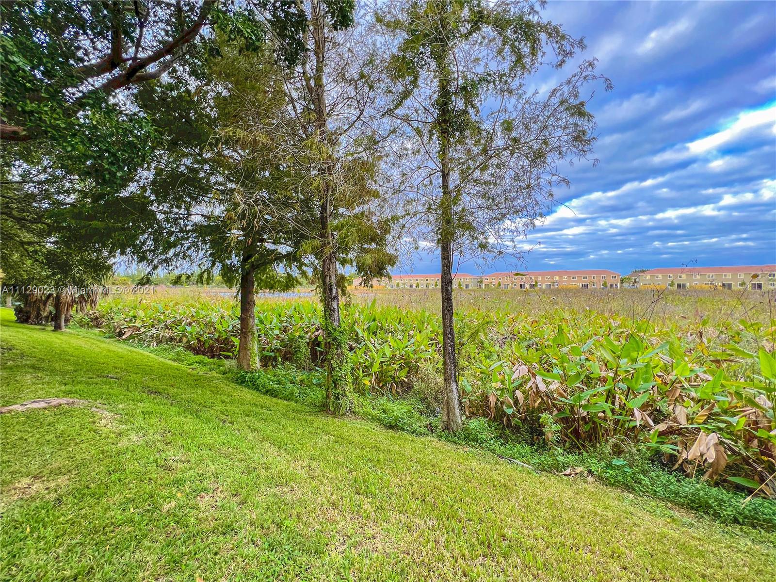 1399 Southeast 20th Road Homestead, FL 33035 - Photo 31 of 50 a view of an outdoor space with a lake view