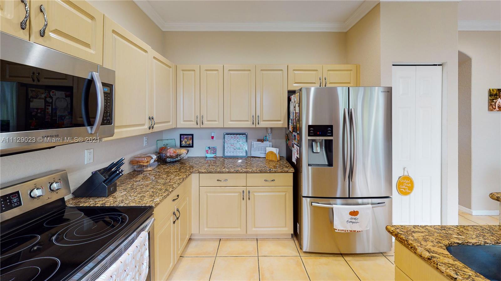 1399 Southeast 20th Road Homestead, FL 33035 - Photo 8 of 50 a kitchen with a sink stove and refrigerator