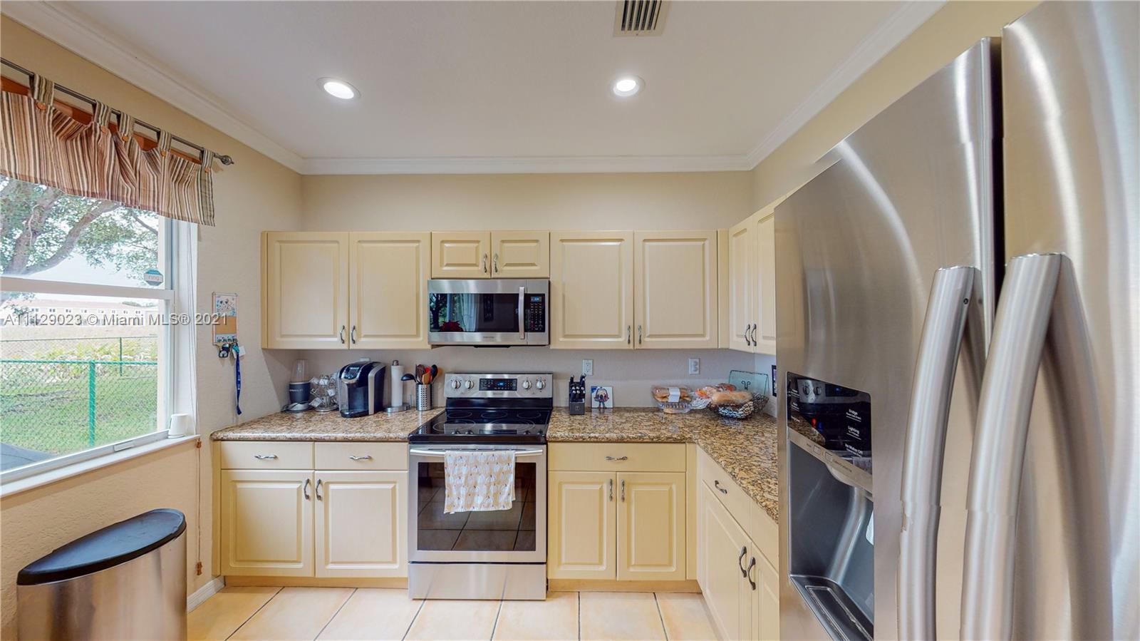 1399 Southeast 20th Road Homestead, FL 33035 - Photo 9 of 50 a kitchen with stainless steel appliances a refrigerator sink and microwave