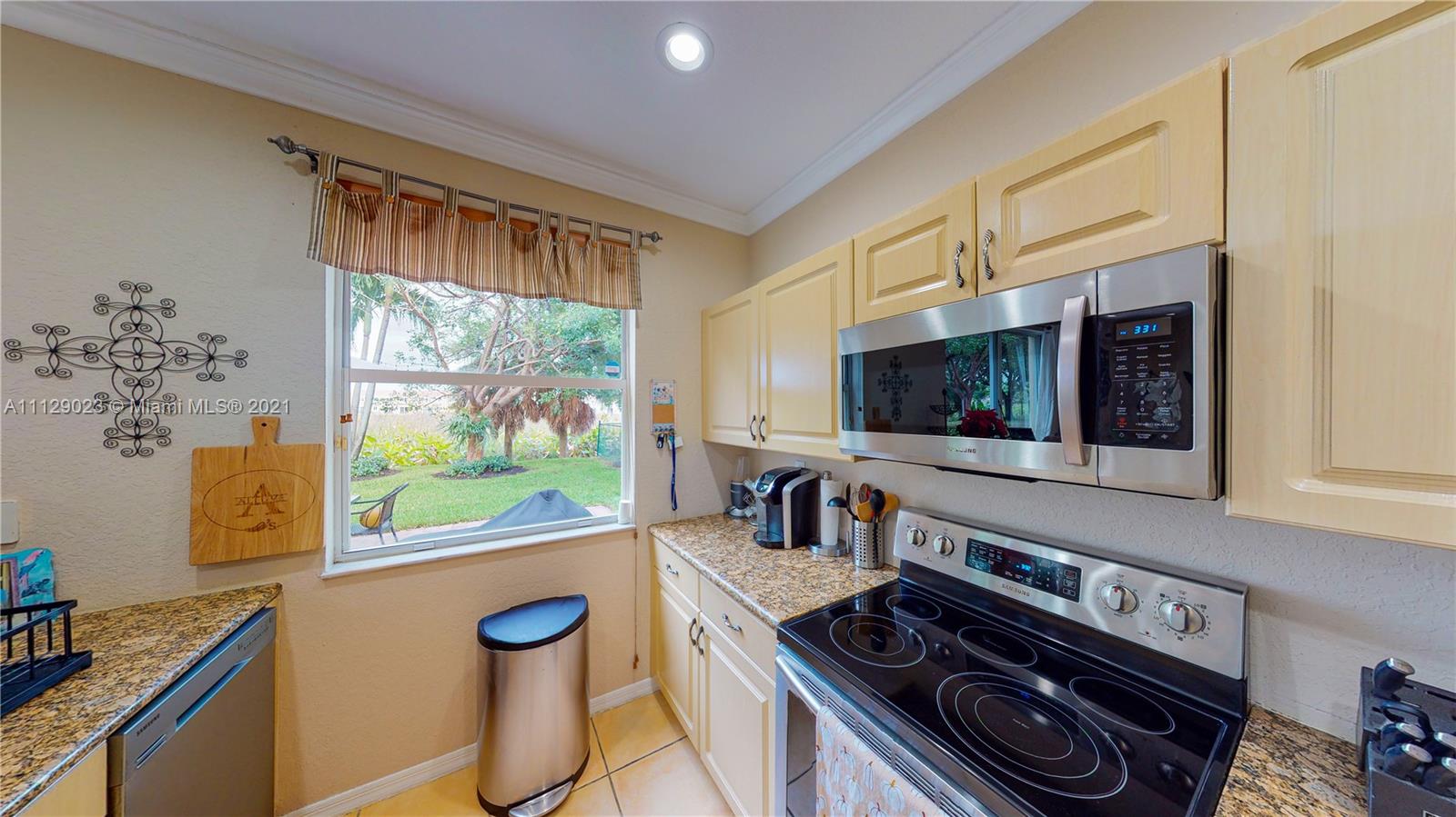 1399 Southeast 20th Road Homestead, FL 33035 - Photo 10 of 50 a kitchen with a stove a sink and a microwave