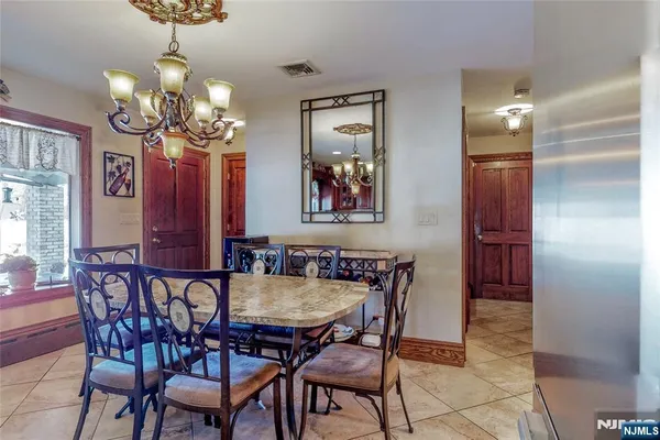a view of a dining room with furniture and chandelier