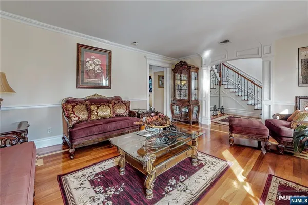 a living room with furniture rug and wooden floor