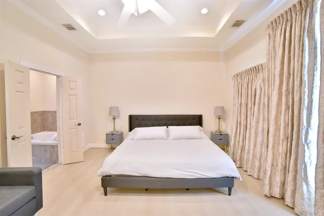 a bedroom with a bed and a large mirror