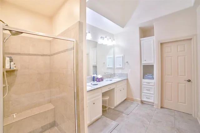 a bathroom with a double vanity sink toilet and shower