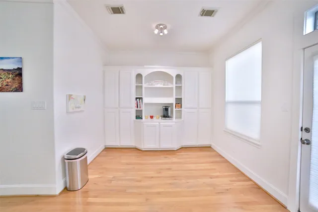 a view of a room with wooden floor and a window