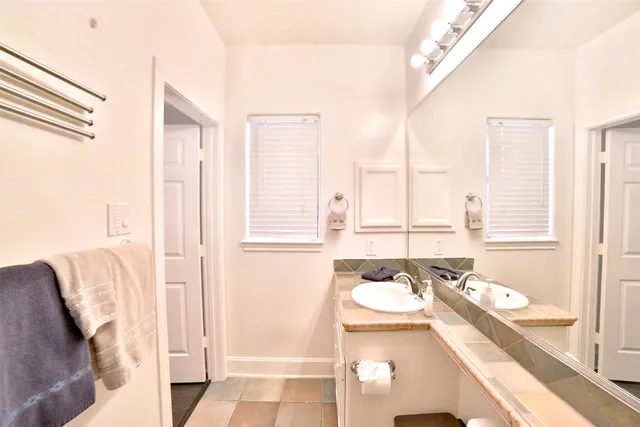 a bathroom with a tub sink and mirror