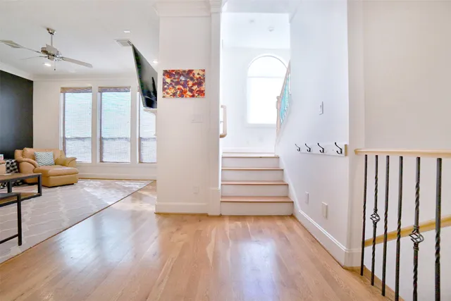 a view of entryway and hall with wooden floor