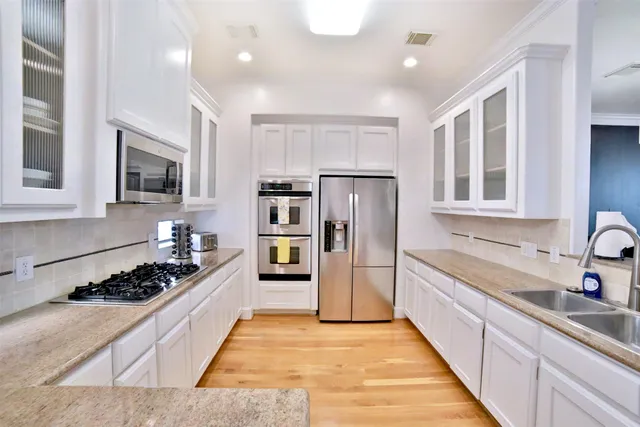 a kitchen with refrigerator and cabinets