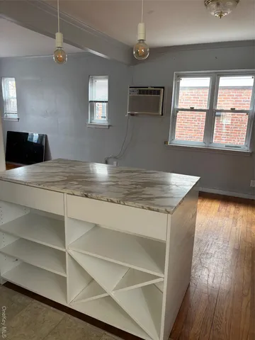 a view of a room with wooden floor and windows