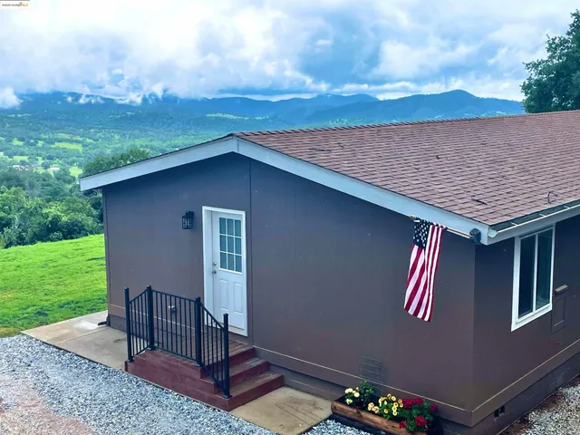 a backyard of a house with table and chairs