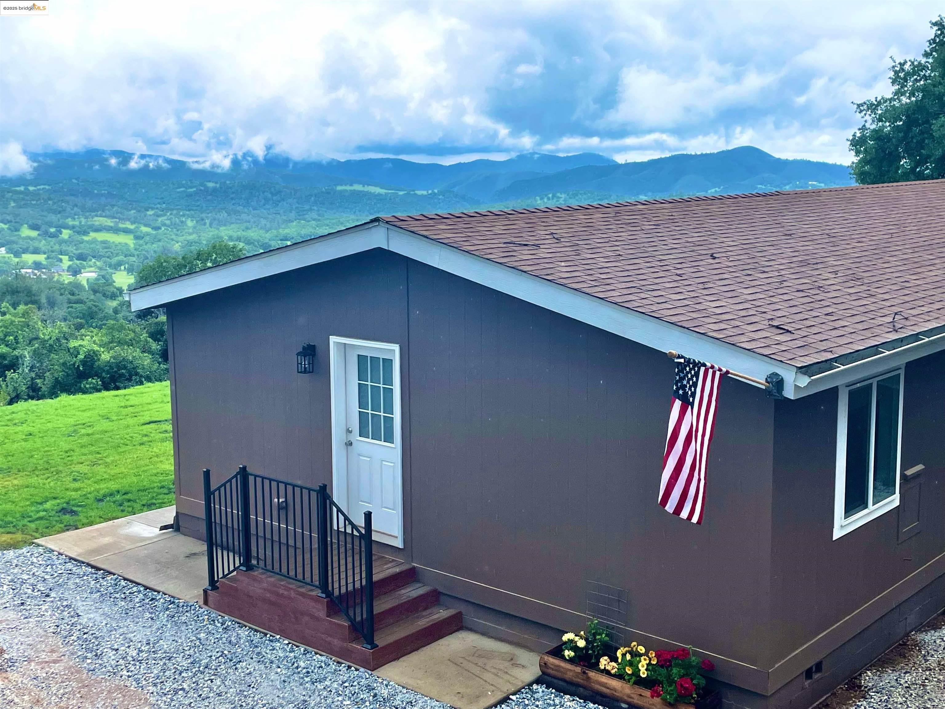 a backyard of a house with table and chairs