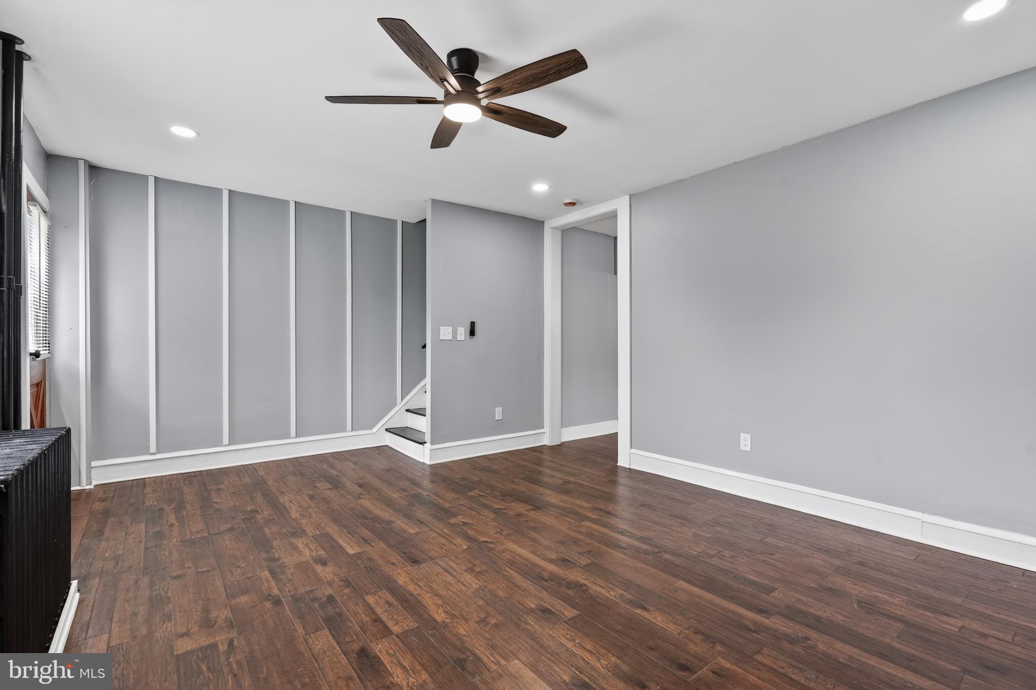 223 Noreg Place Brooklawn, NJ 08030 - Photo 10 of 36 an empty room with wooden floor and windows