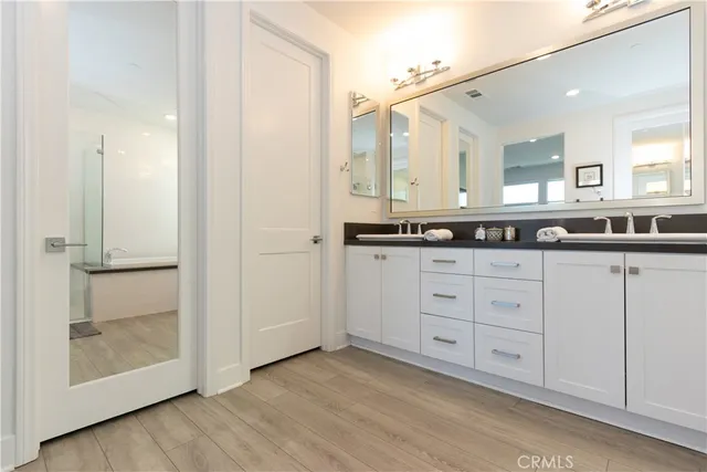 a bathroom with a double vanity sink and mirror