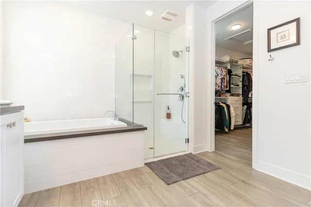 a view of walk in closet with clothes and shoes