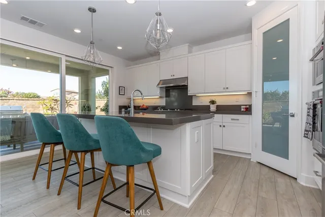 a dining hall with stainless steel appliances granite countertop a stove and kitchen view