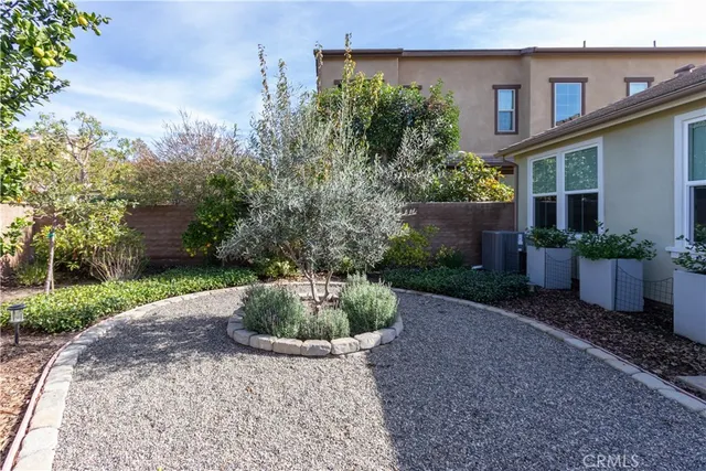 a view of a swimming pool with outdoor seating and plants