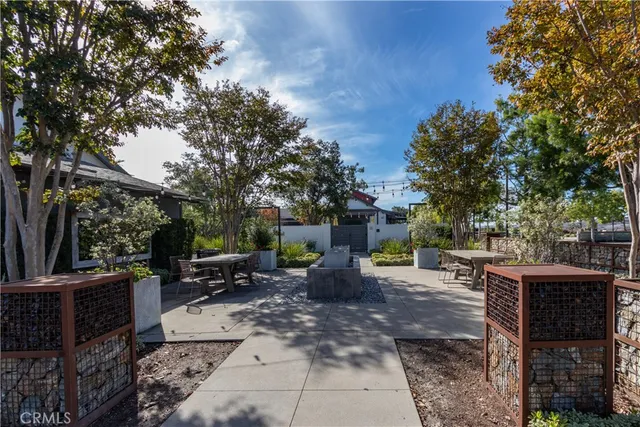 an aerial view of residential houses with outdoor space and parking