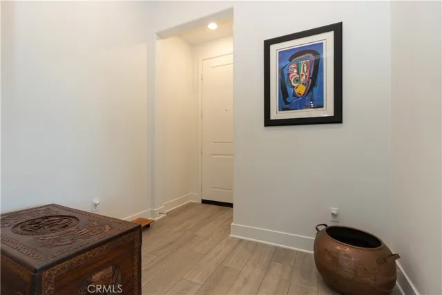 a view of an empty room with a painting on the wall