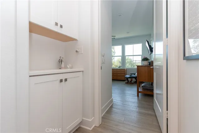 a view of a room that has a window and wooden floor