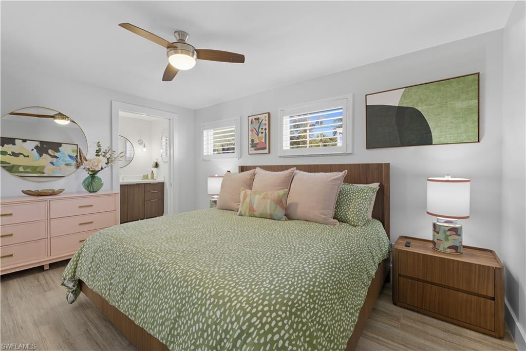 609 12th Avenue South, Unit 609 Naples, FL 34102 - Photo 13 of 32 a bed room with a bed and a painting