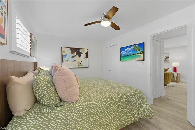 a bedroom with a bed and painting on the wall