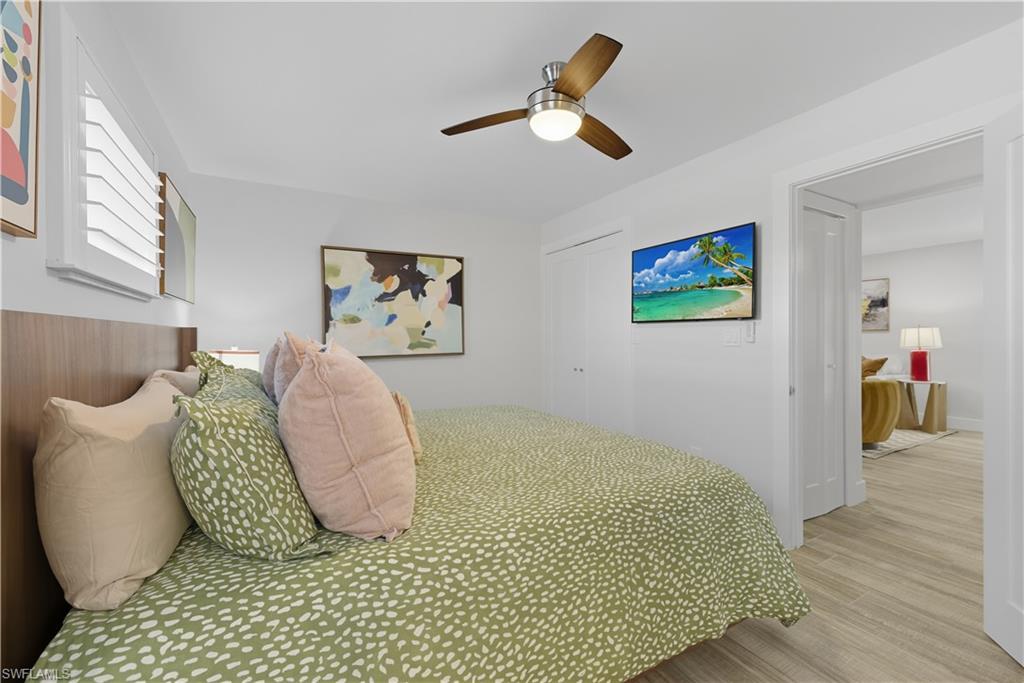 609 12th Avenue South, Unit 609 Naples, FL 34102 - Photo 14 of 32 a bedroom with a bed and painting on the wall