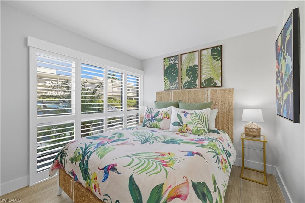 609 12th Avenue South, Unit 609 Naples, FL 34102 - Photo 16 of 32 a bedroom with a bed and a window