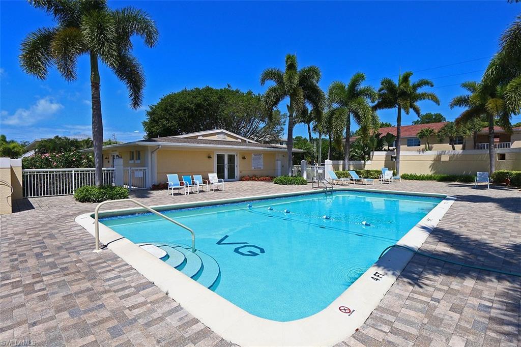 609 12th Avenue South, Unit 609 Naples, FL 34102 - Photo 20 of 32 a view of a swimming pool with lounge chairs