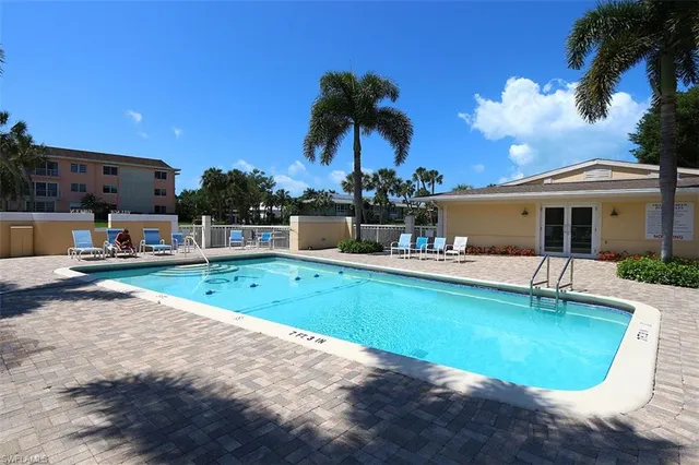 a view of a house with swimming pool and sitting area
