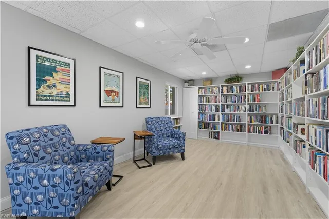 a living room with furniture and a book shelf