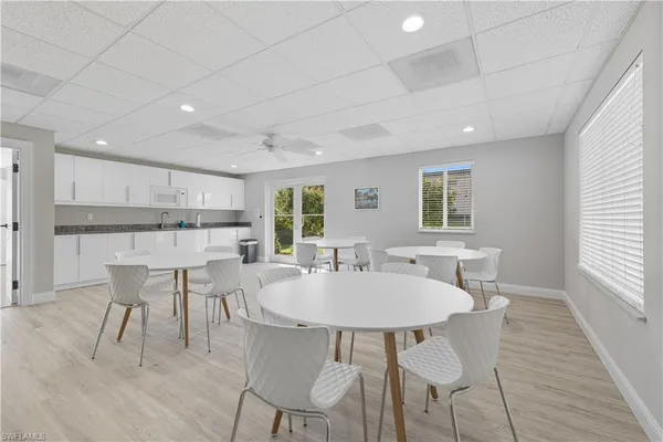 a kitchen with kitchen island a dining table and chairs