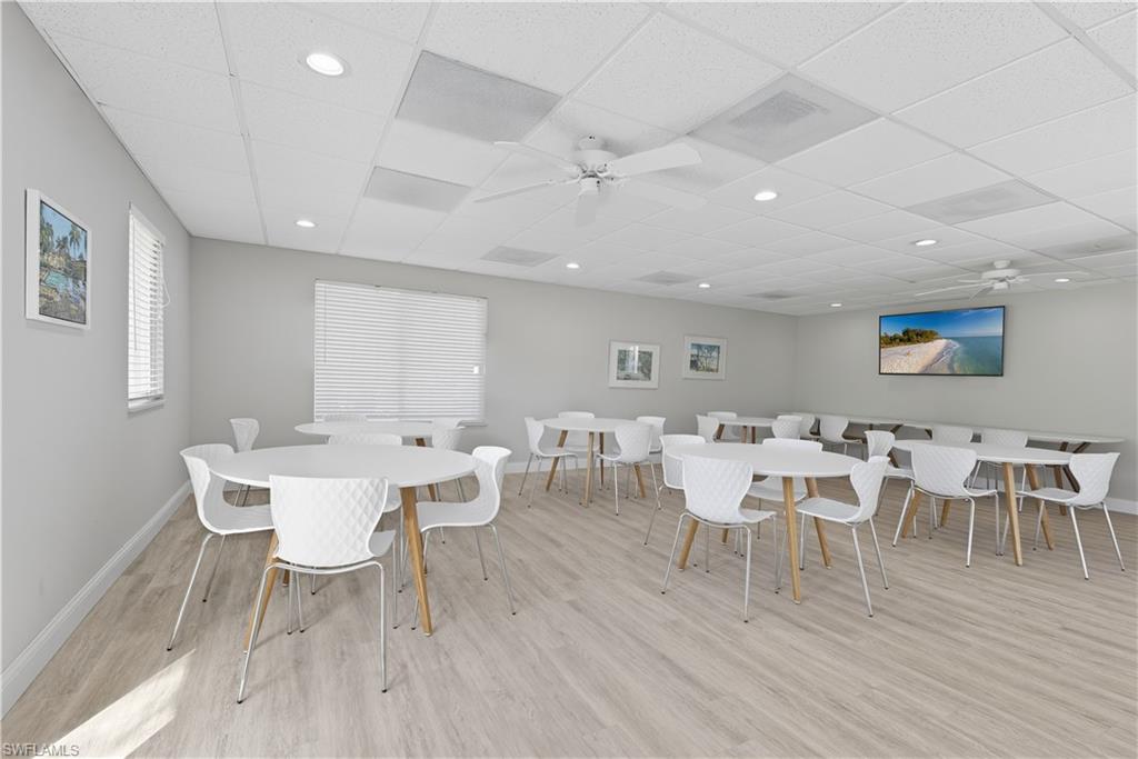 609 12th Avenue South, Unit 609 Naples, FL 34102 - Photo 25 of 32 a view of a dining room with furniture and wooden floor