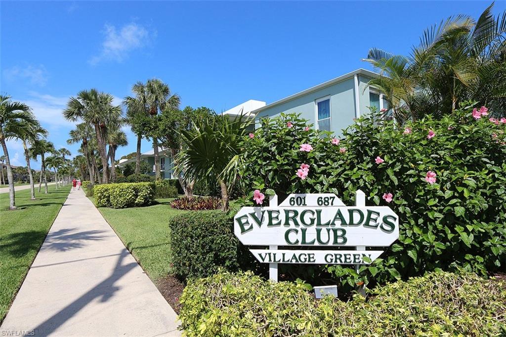 609 12th Avenue South, Unit 609 Naples, FL 34102 - Photo 26 of 32 a view of a house with a yard and table in patio