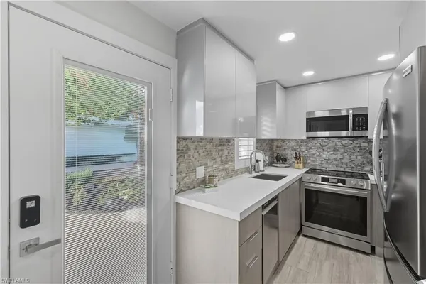a kitchen with a stove a sink and a refrigerator
