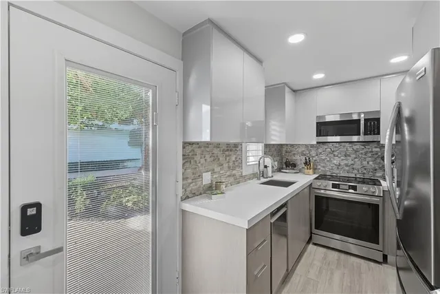a kitchen with a stove a sink and a refrigerator