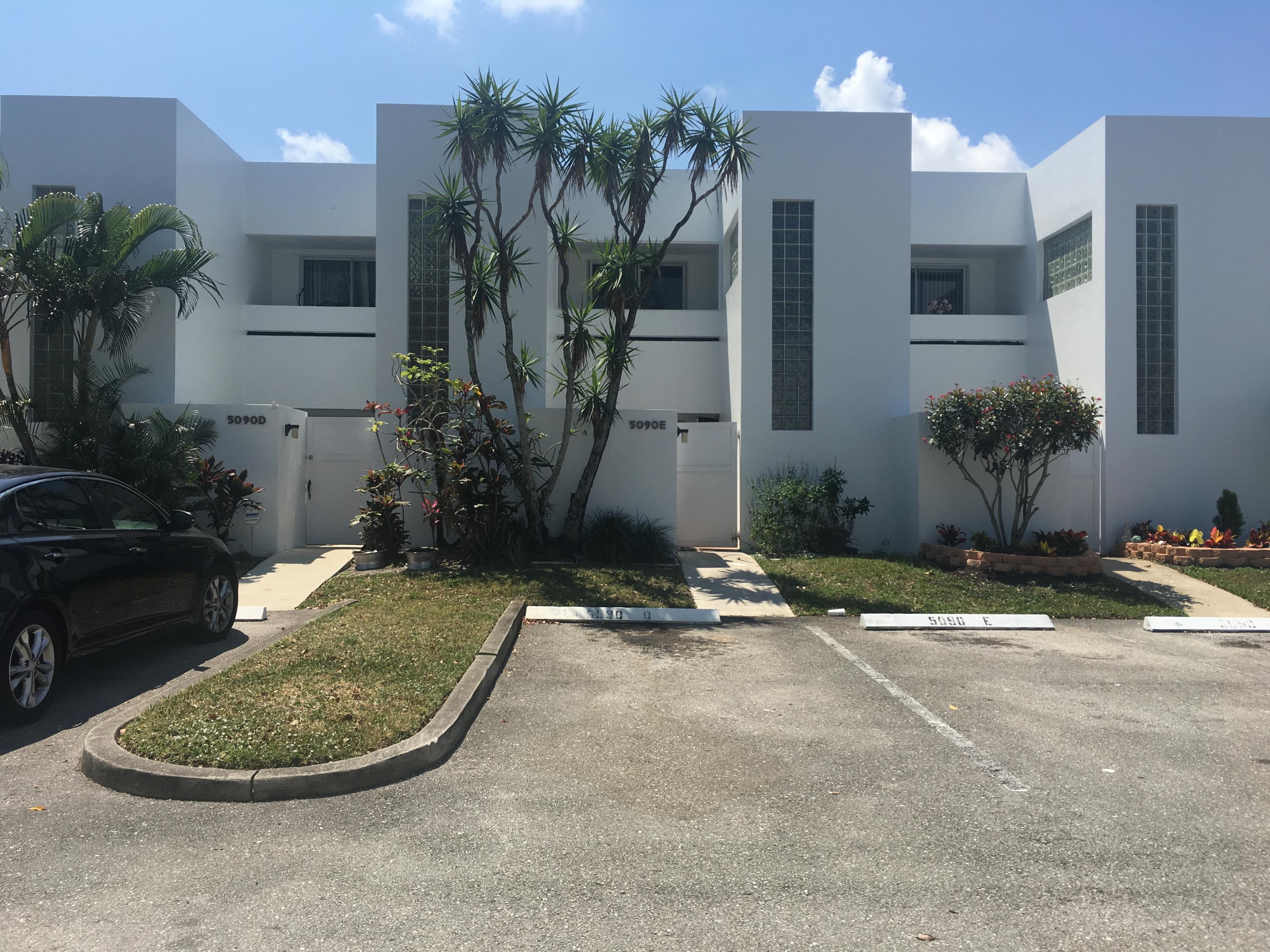5090 Elmhurst Road, Unit E West Palm Beach, FL 33417 - Photo 2 of 12 a view of a house with a backyard