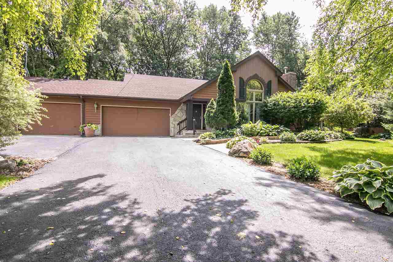5477 Tate Road Rockford, IL 61101 - Photo 1 of 25 a front view of a house with a yard and garage