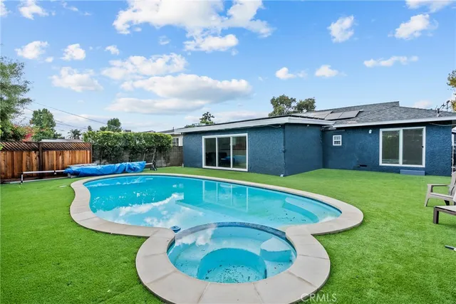 a view of a house with a backyard