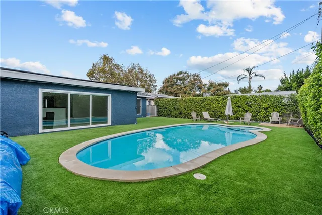 a kitchen with stainless steel appliances granite countertop a refrigerator sink and microwave