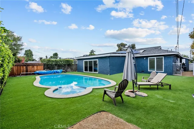 a view of kitchen with stainless steel appliances refrigerator stove microwave and cabinets